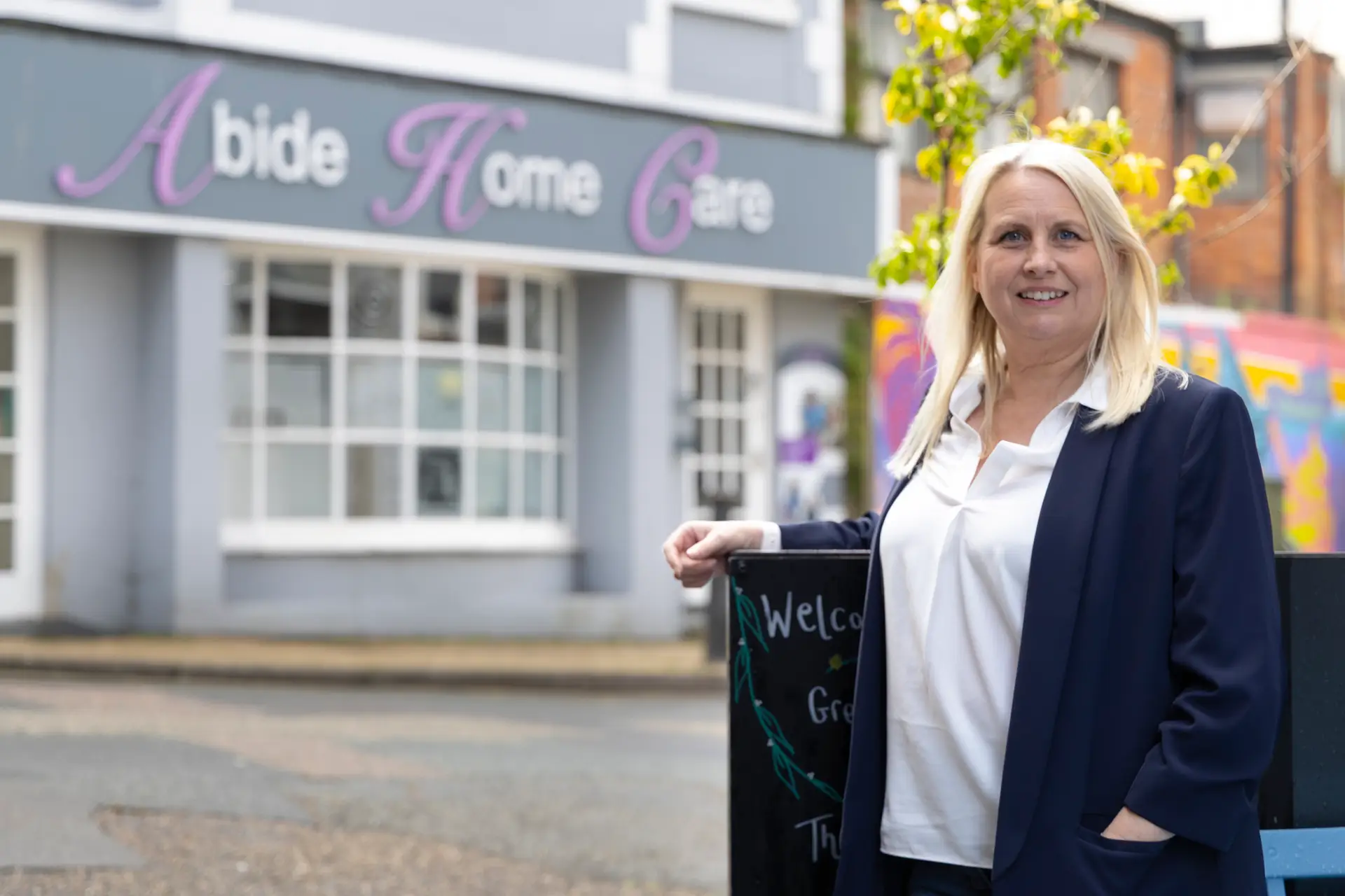 Abide owner standing outside the Abide Home Care building in Brixham.